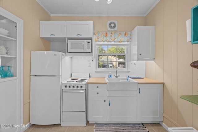 215C Battleground Ave, New Bern, NC 28560 - kitchen with white appliances, white cabinetry, ornamental molding, light tile patterned floors, and decorative backsplash