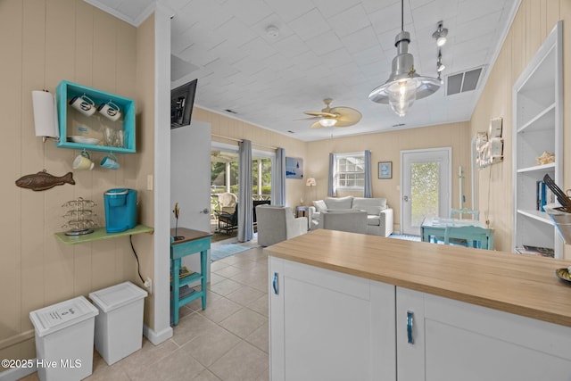 215C Battleground Ave, New Bern, NC 28560 - kitchen with wooden counters, ceiling fan, open floor plan, light tile patterned floors, and white cabinetry