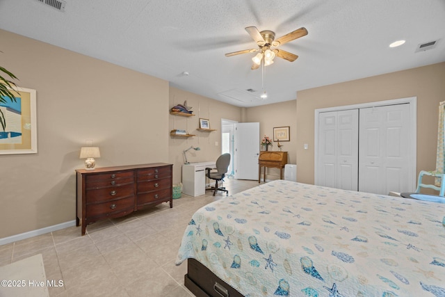 215C Battleground Ave, New Bern, NC 28560 - bedroom featuring light tile patterned floors, a closet, a ceiling fan, and a textured ceiling