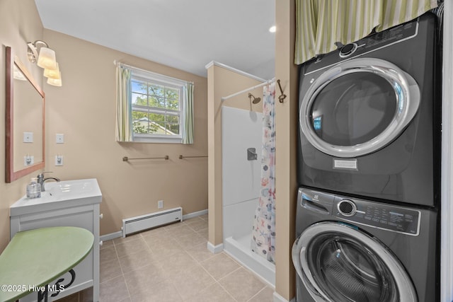 215C Battleground Ave, New Bern, NC 28560 - washroom with estacked washer and dryer, a baseboard heating unit, and light tile patterned flooring