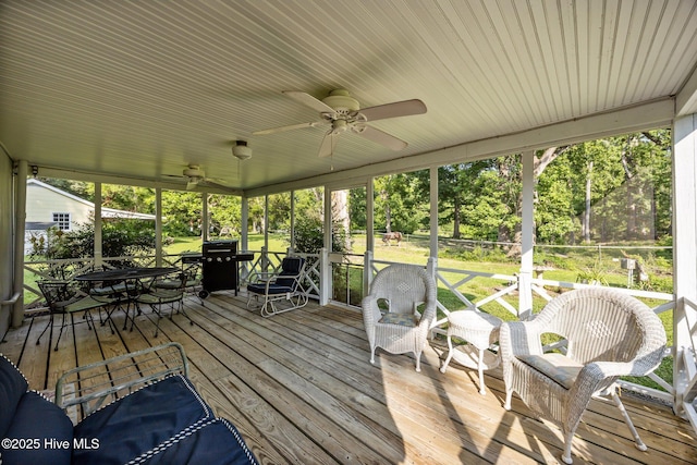 215C Battleground Ave, New Bern, NC 28560 - wooden deck featuring ceiling fan, outdoor dining area, a yard, and view of wooded area