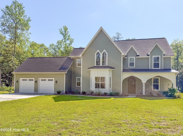 1009 Michael Dr, New Bern, NC 28560 - view of front of home featuring a standing seam roof, an attached garage, concrete driveway, a front lawn, and a metal roof