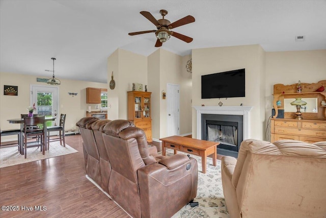 136 Van Riggs Rd, Hubert, NC 28539 - living room featuring ceiling fan, a fireplace, vaulted ceiling, and wood finished floors