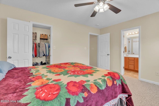 136 Van Riggs Rd, Hubert, NC 28539 - bedroom featuring light carpet, ensuite bath, a spacious closet, a ceiling fan, and a closet