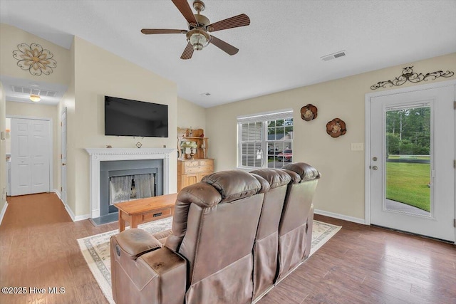 136 Van Riggs Rd, Hubert, NC 28539 - living room with lofted ceiling, a fireplace with flush hearth, plenty of natural light, and wood finished floors