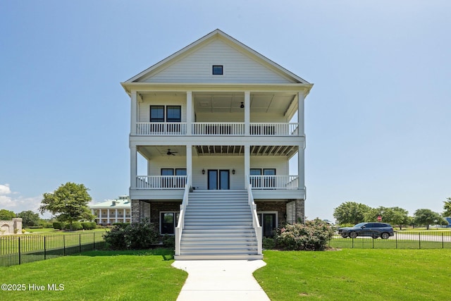 520 Cannonsgate Dr, Newport, NC 28570 - coastal inspired home featuring stairway, a porch, a balcony, and a ceiling fan