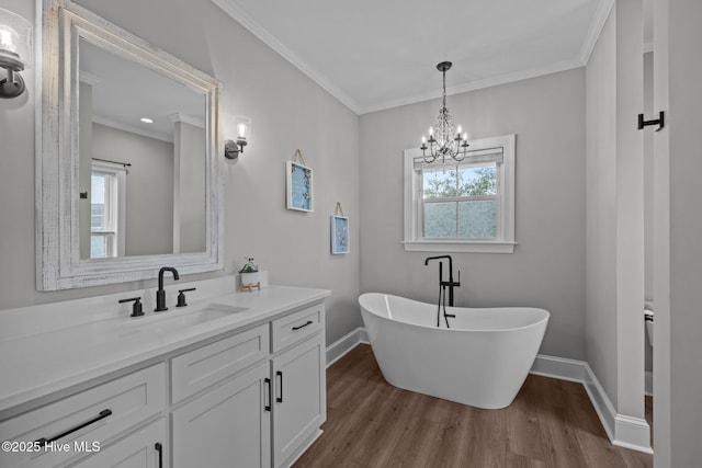 520 Cannonsgate Dr, Newport, NC 28570 - bathroom with plenty of natural light, a freestanding bath, wood finished floors, and crown molding