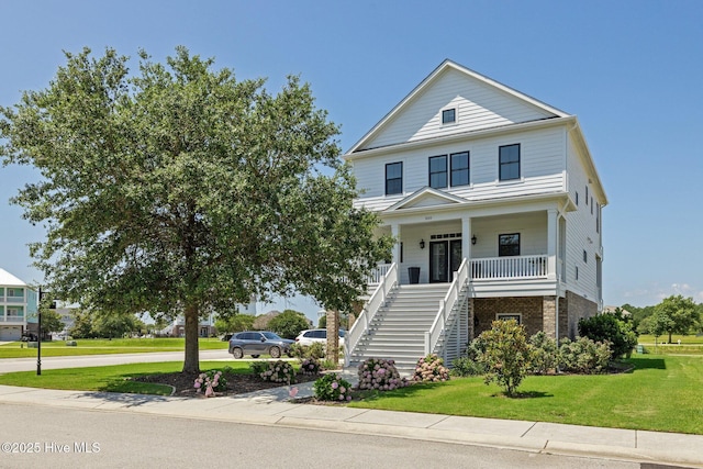 520 Cannonsgate Dr, Newport, NC 28570 - beach home with stairs, covered porch, brick siding, and a front yard