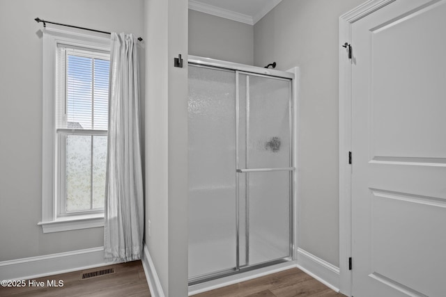520 Cannonsgate Dr, Newport, NC 28570 - bathroom with crown molding, wood finished floors, a stall shower, and healthy amount of natural light