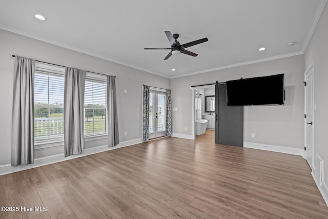 520 Cannonsgate Dr, Newport, NC 28570 - unfurnished living room with a barn door, ceiling fan, light wood finished floors, crown molding, and recessed lighting