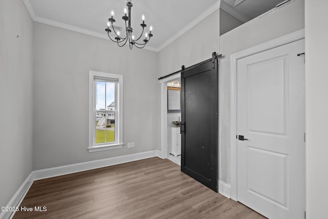 520 Cannonsgate Dr, Newport, NC 28570 - unfurnished dining area featuring crown molding, wood finished floors, a barn door, and a chandelier