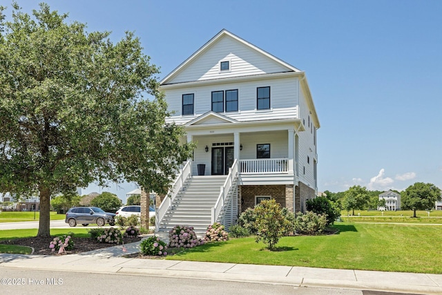 520 Cannonsgate Dr, Newport, NC 28570 - view of front of property with stairway, covered porch, a front yard, and brick siding