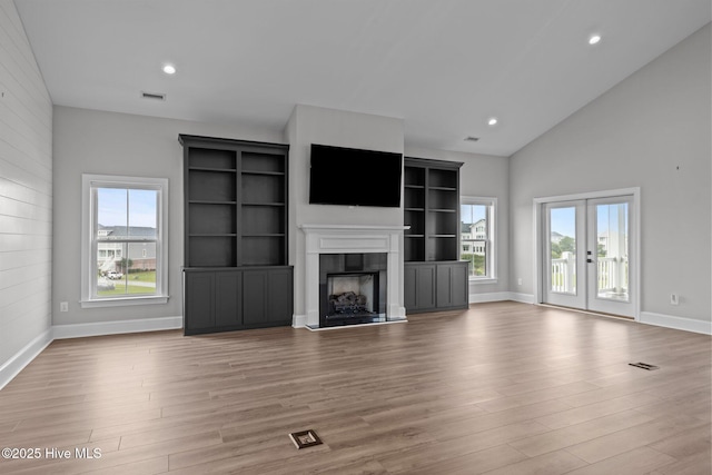 520 Cannonsgate Dr, Newport, NC 28570 - unfurnished living room with wood finished floors, a fireplace, recessed lighting, high vaulted ceiling, and french doors