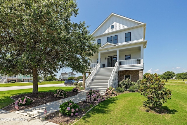 520 Cannonsgate Dr, Newport, NC 28570 - raised beach house with stairway, a front yard, covered porch, and brick siding