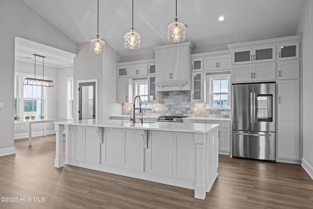 520 Cannonsgate Dr, Newport, NC 28570 - kitchen featuring stainless steel appliances, light countertops, decorative backsplash, a center island with sink, and lofted ceiling
