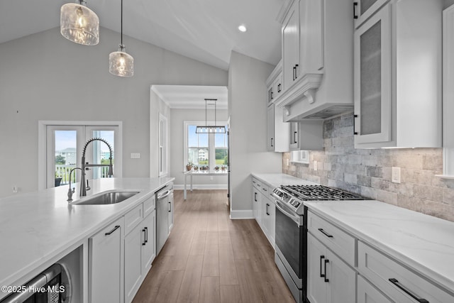 520 Cannonsgate Dr, Newport, NC 28570 - kitchen featuring appliances with stainless steel finishes, glass insert cabinets, white cabinetry, tasteful backsplash, and light stone counters