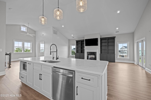 520 Cannonsgate Dr, Newport, NC 28570 - kitchen with dishwasher, open floor plan, high vaulted ceiling, light wood-type flooring, and white cabinetry