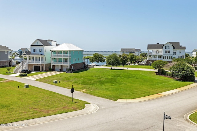 520 Cannonsgate Dr, Newport, NC 28570 - view of property's community with an attached garage, a water view, a lawn, and driveway
