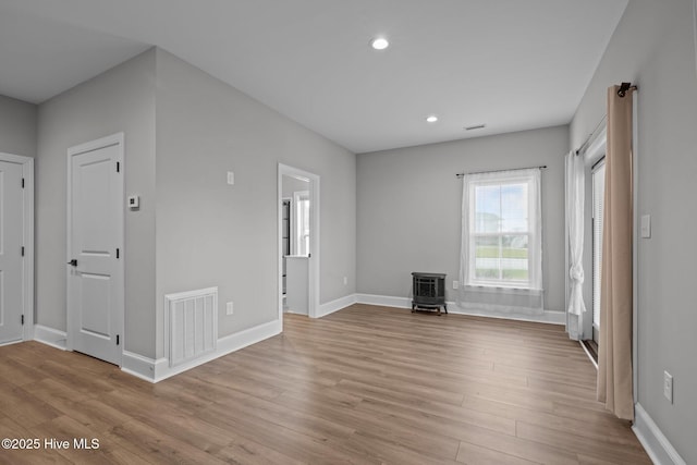 520 Cannonsgate Dr, Newport, NC 28570 - unfurnished living room with a wood stove, wood finished floors, and recessed lighting