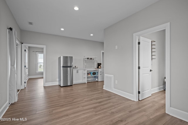 520 Cannonsgate Dr, Newport, NC 28570 - unfurnished living room featuring light wood-style flooring and recessed lighting