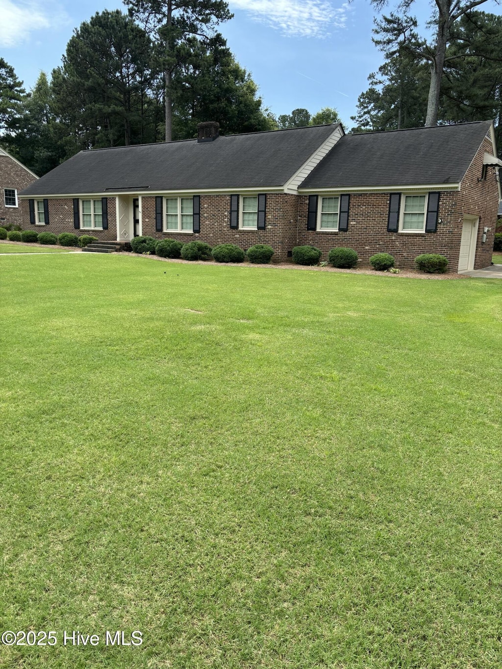 211 Forest Hills Rd NW, Wilson, NC 27896 - ranch-style house with brick siding, a front lawn, and a garage