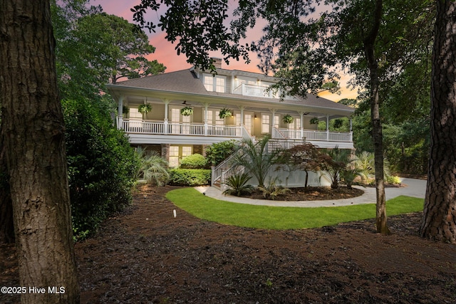 733 Legare Ln SW, Supply, NC 28462 - back of property at dusk featuring covered porch and stairway