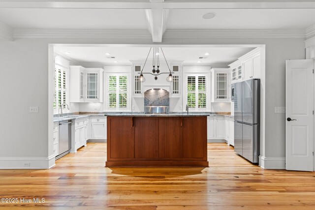 733 Legare Ln SW, Supply, NC 28462 - kitchen featuring stainless steel appliances, light wood-style flooring, white cabinets, a kitchen island, and crown molding
