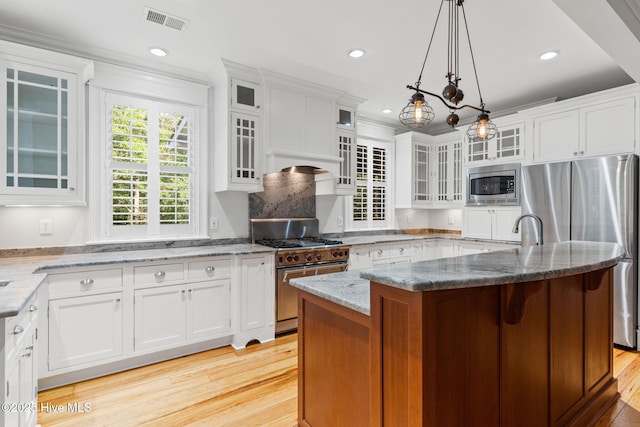 733 Legare Ln SW, Supply, NC 28462 - kitchen with stainless steel appliances, white cabinets, light wood-style flooring, crown molding, and recessed lighting