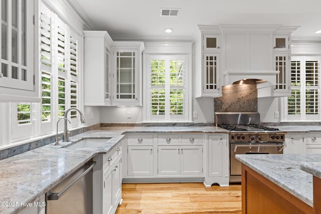 733 Legare Ln SW, Supply, NC 28462 - kitchen featuring appliances with stainless steel finishes, a sink, white cabinetry, crown molding, and light wood-style floors