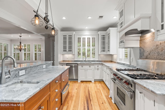 733 Legare Ln SW, Supply, NC 28462 - kitchen featuring appliances with stainless steel finishes, a sink, crown molding, a warming drawer, and white cabinets