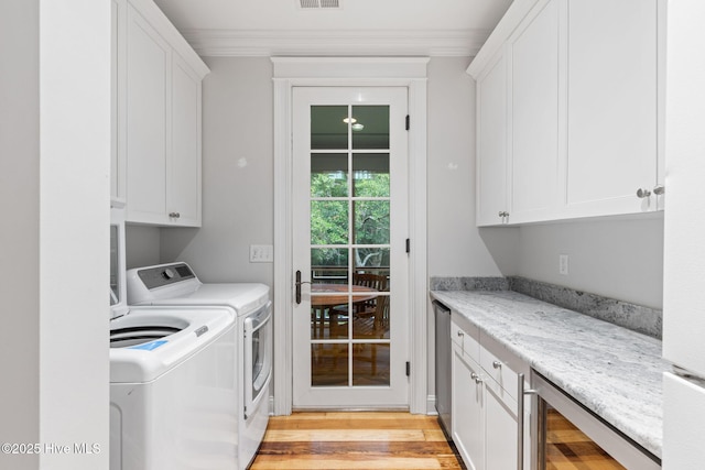 733 Legare Ln SW, Supply, NC 28462 - laundry area featuring cabinet space, washing machine and dryer, wine cooler, light wood-style floors, and ornamental molding