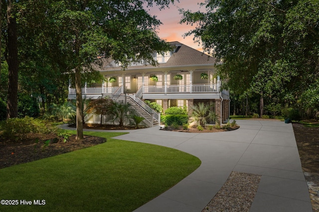 733 Legare Ln SW, Supply, NC 28462 - view of front facade with a porch, stairway, a lawn, and brick siding