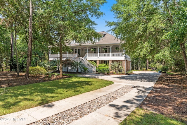 733 Legare Ln SW, Supply, NC 28462 - beach home with stairway, a porch, a front lawn, and concrete driveway