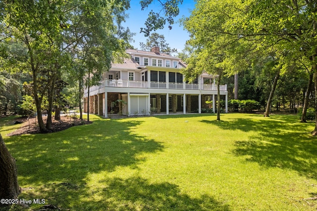 733 Legare Ln SW, Supply, NC 28462 - back of house featuring a sunroom, a lawn, a chimney, and a wooden deck
