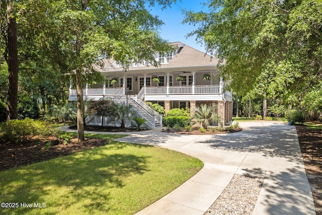 733 Legare Ln SW, Supply, NC 28462 - beach home featuring a porch, stairs, a front lawn, a ceiling fan, and concrete driveway