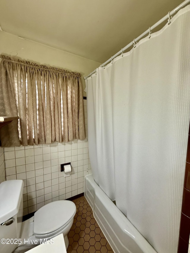 110 N Main St, Colerain, NC 27924 - bathroom featuring toilet, shower / bathtub combination with curtain, tile walls, and tile patterned floors