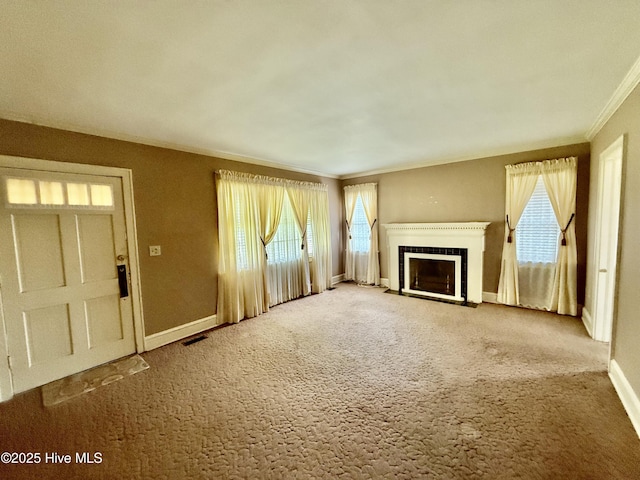 110 N Main St, Colerain, NC 27924 - unfurnished living room featuring crown molding, a fireplace with flush hearth, carpet floors, and baseboards