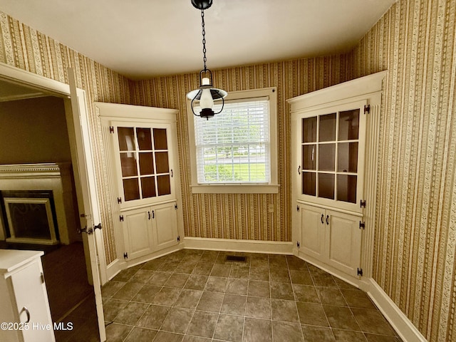 110 N Main St, Colerain, NC 27924 - unfurnished dining area with wallpapered walls, baseboards, and dark tile patterned floors