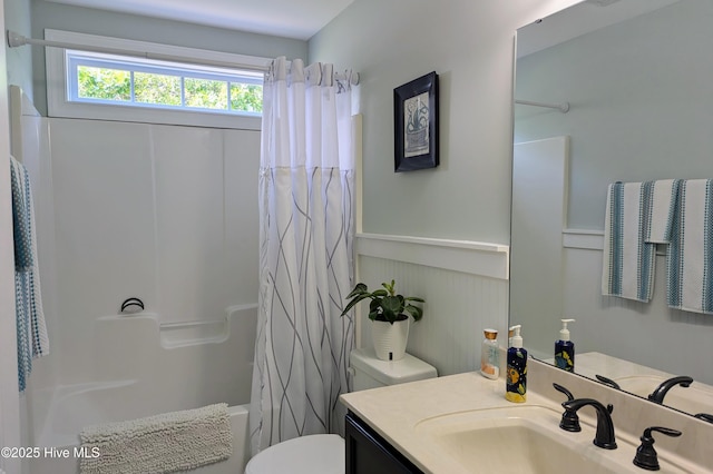 502 Vanderhorst Ave, Shallotte, NC 28470 - full bathroom with vanity, toilet, shower / tub combo, and a wainscoted wall