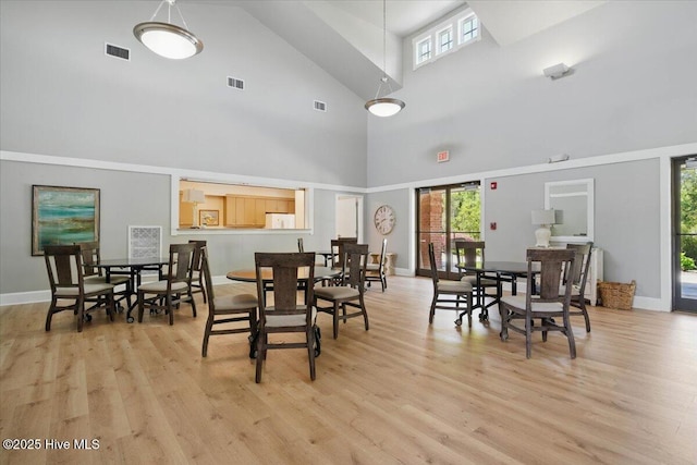 502 Vanderhorst Ave, Shallotte, NC 28470 - dining room with a towering ceiling, light wood-style floors, and healthy amount of natural light