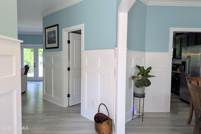 502 Vanderhorst Ave, Shallotte, NC 28470 - hall featuring crown molding, light wood-style flooring, a decorative wall, french doors, and a wainscoted wall
