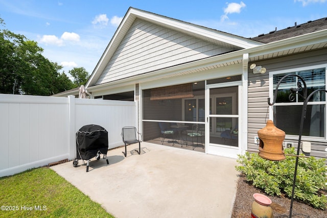 6476 Merceron St Unit 2B, Ocean Isle Beach, NC 28469 - view of patio featuring a sunroom and grilling area
