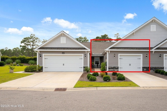 6476 Merceron St Unit 2B, Ocean Isle Beach, NC 28469 - view of front of house with driveway, stone siding, a shingled roof, and a garage