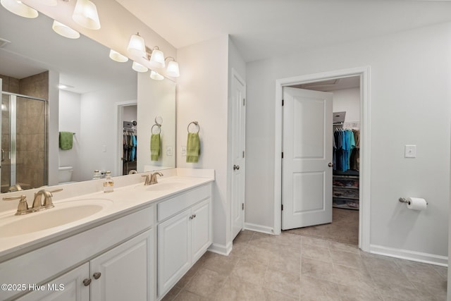 6476 Merceron St Unit 2B, Ocean Isle Beach, NC 28469 - full bath with a spacious closet, double vanity, a stall shower, and tile patterned floors