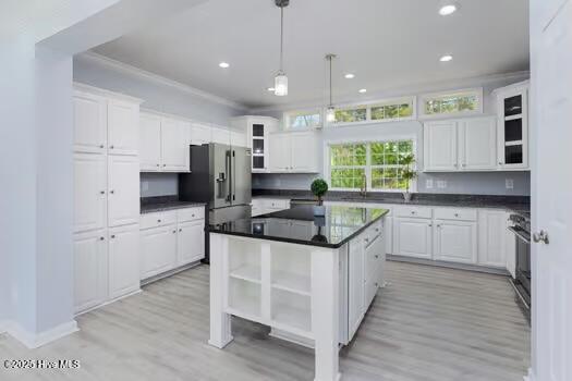 225 Factory Rd, Hampstead, NC 28443 - kitchen featuring open shelves, white cabinets, dark countertops, recessed lighting, and a kitchen island