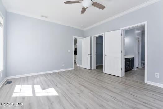 225 Factory Rd, Hampstead, NC 28443 - unfurnished bedroom with wood finished floors, ornamental molding, baseboards, a walk in closet, and ceiling fan