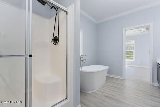 225 Factory Rd, Hampstead, NC 28443 - bathroom featuring crown molding, a shower stall, vanity, wood finished floors, and a freestanding tub