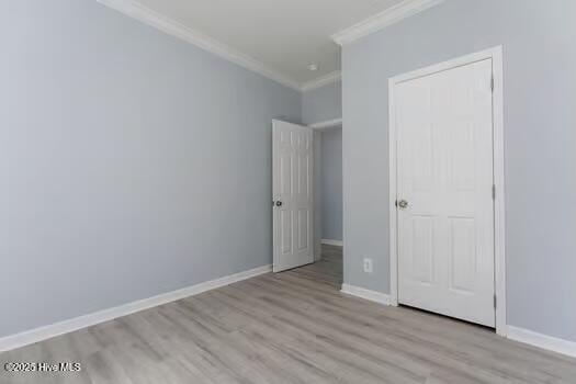 225 Factory Rd, Hampstead, NC 28443 - unfurnished bedroom with crown molding, wood finished floors, and baseboards