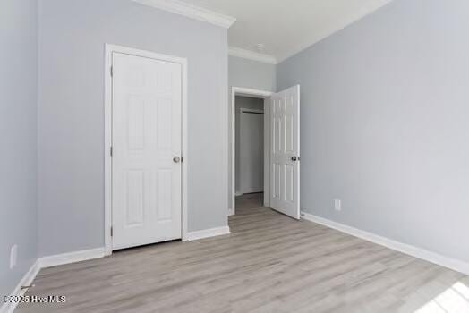 225 Factory Rd, Hampstead, NC 28443 - unfurnished bedroom featuring wood finished floors, ornamental molding, and baseboards