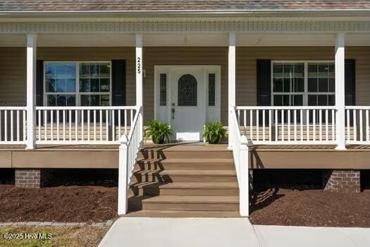 225 Factory Rd, Hampstead, NC 28443 - property entrance featuring covered porch and roof with shingles